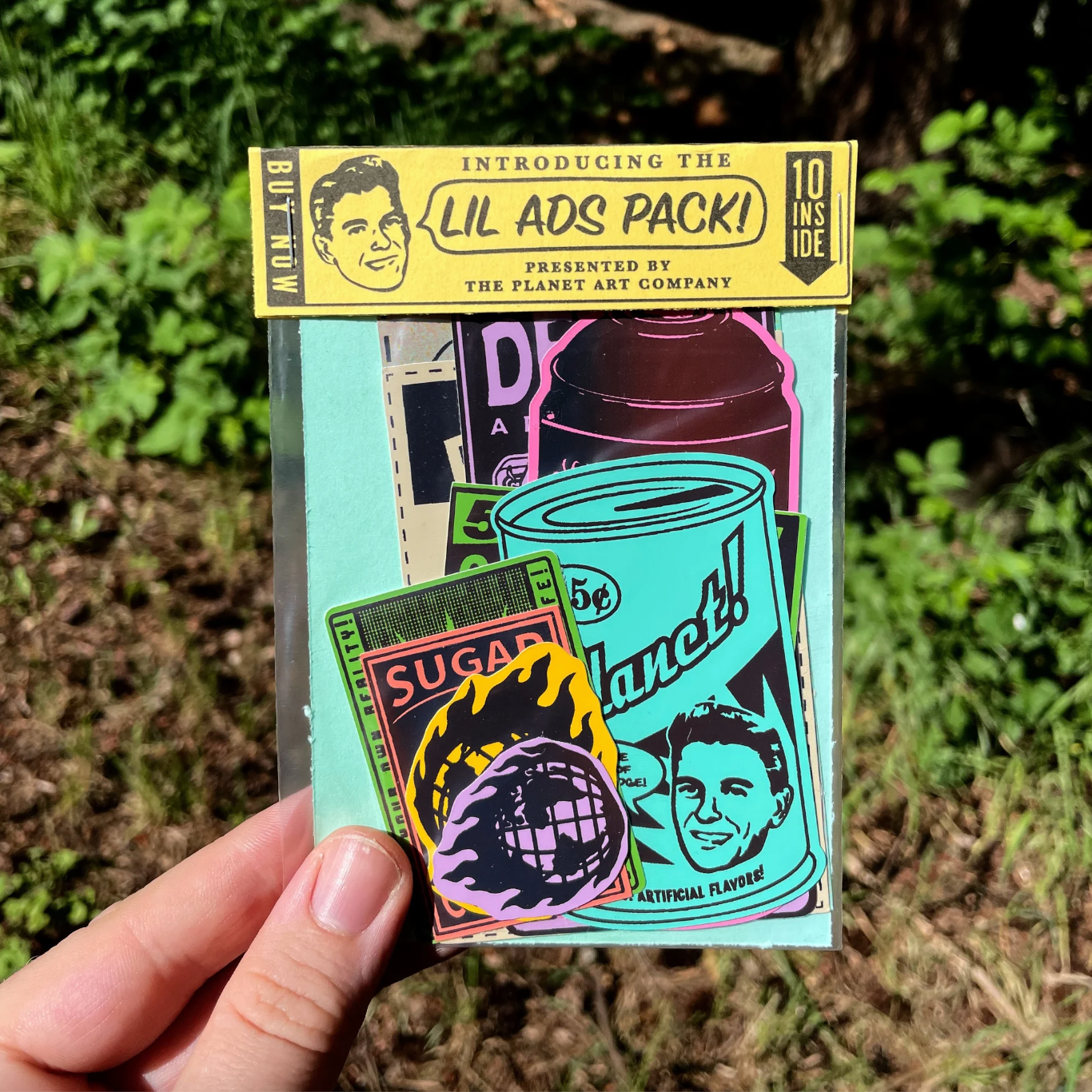 Sticker pack with the text "Lil Ads Pack" against a background of plants. 