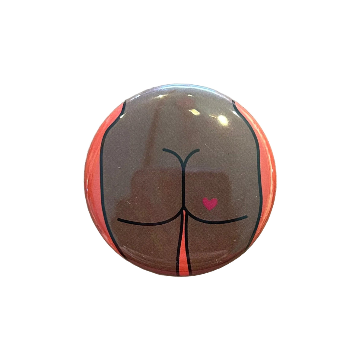 Round button with a butt design with a heart tattoo
