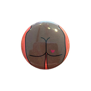 Round button with a butt design with a heart tattoo