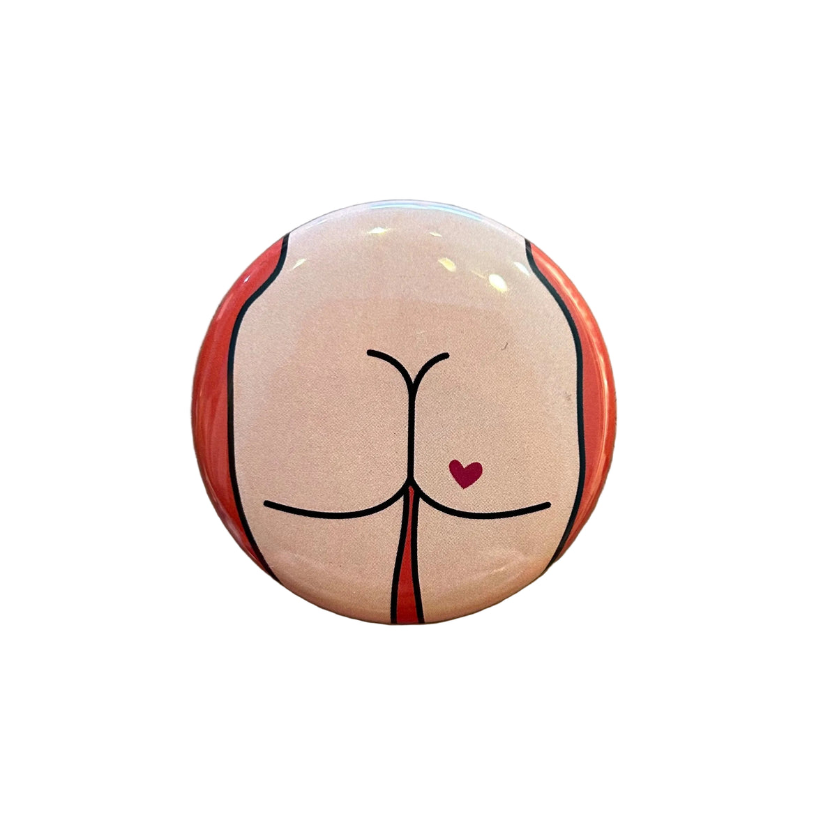 Round button with a design of a stylized butt on a textured surface