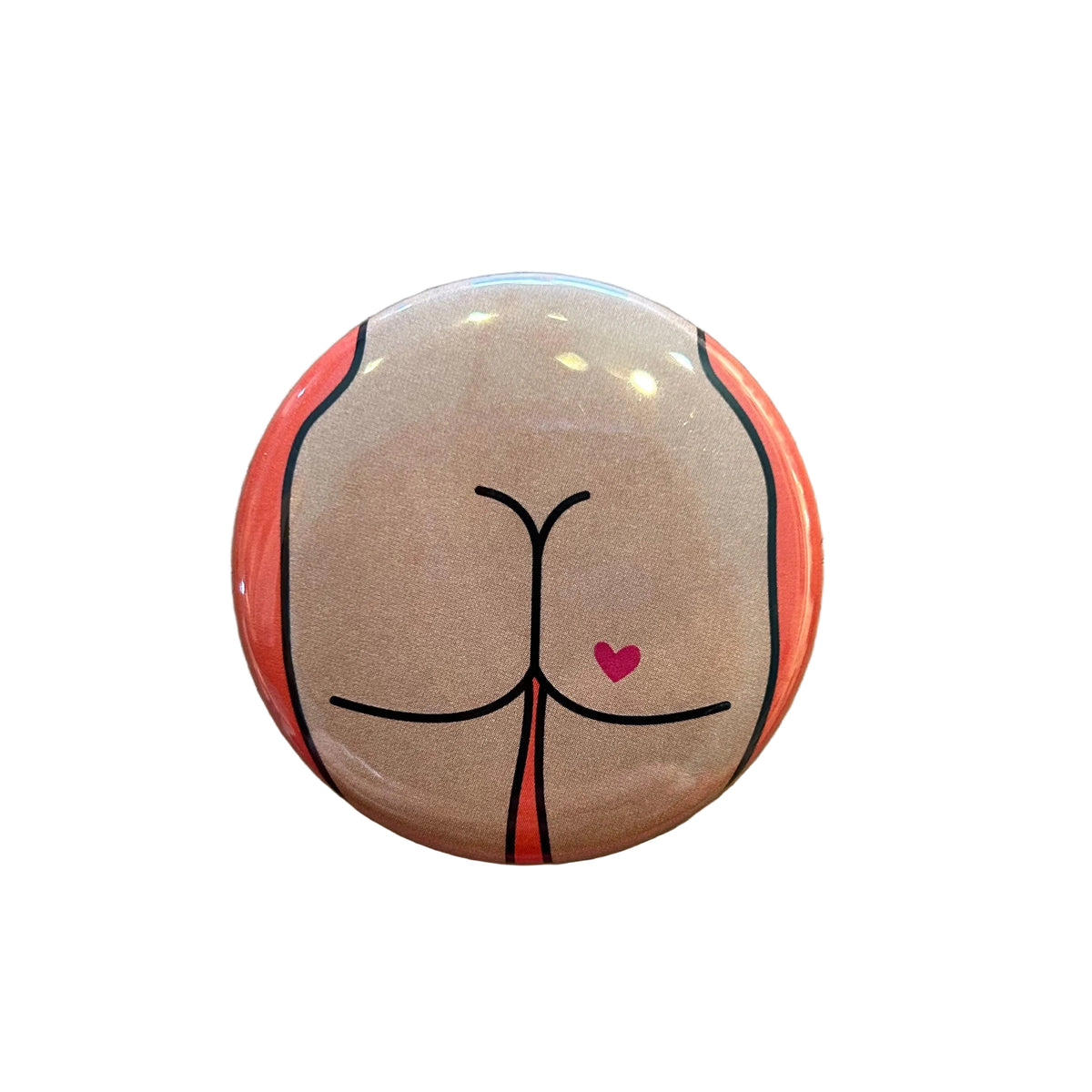 Round button with a design of a butt with a heart tattoo against an orange background. 