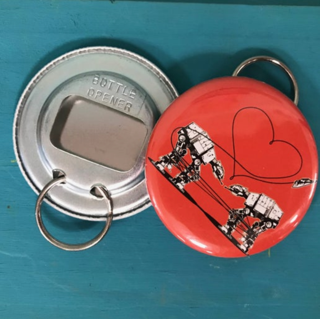 Bottle opener with a red robot design and heart on a blue background