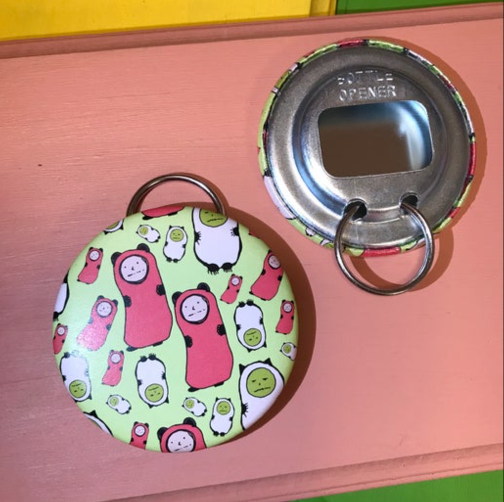 Bottle opener with character design on a pink surface