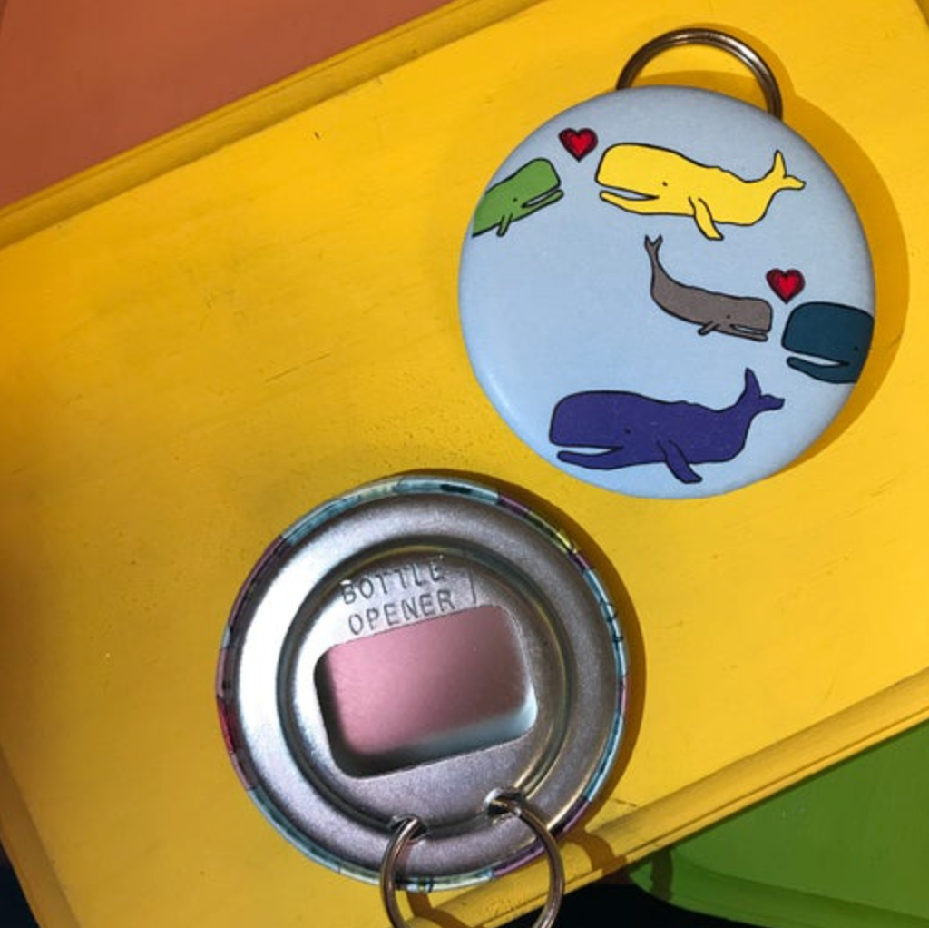 Bottle opener with whale designs on a yellow background