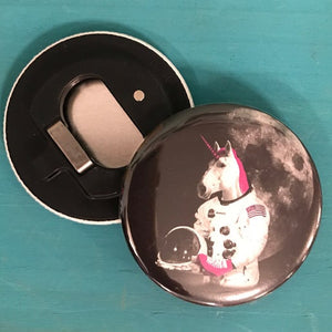 Unicorn astronaut bottle opener on a teal background