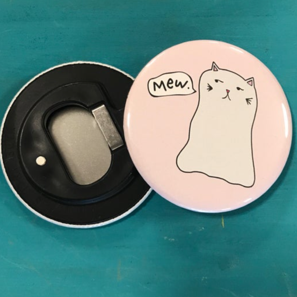 Bottle opener magnet with a cartoon cat design on a teal background