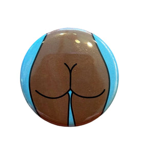 Button badge with a stylized depiction of buttocks