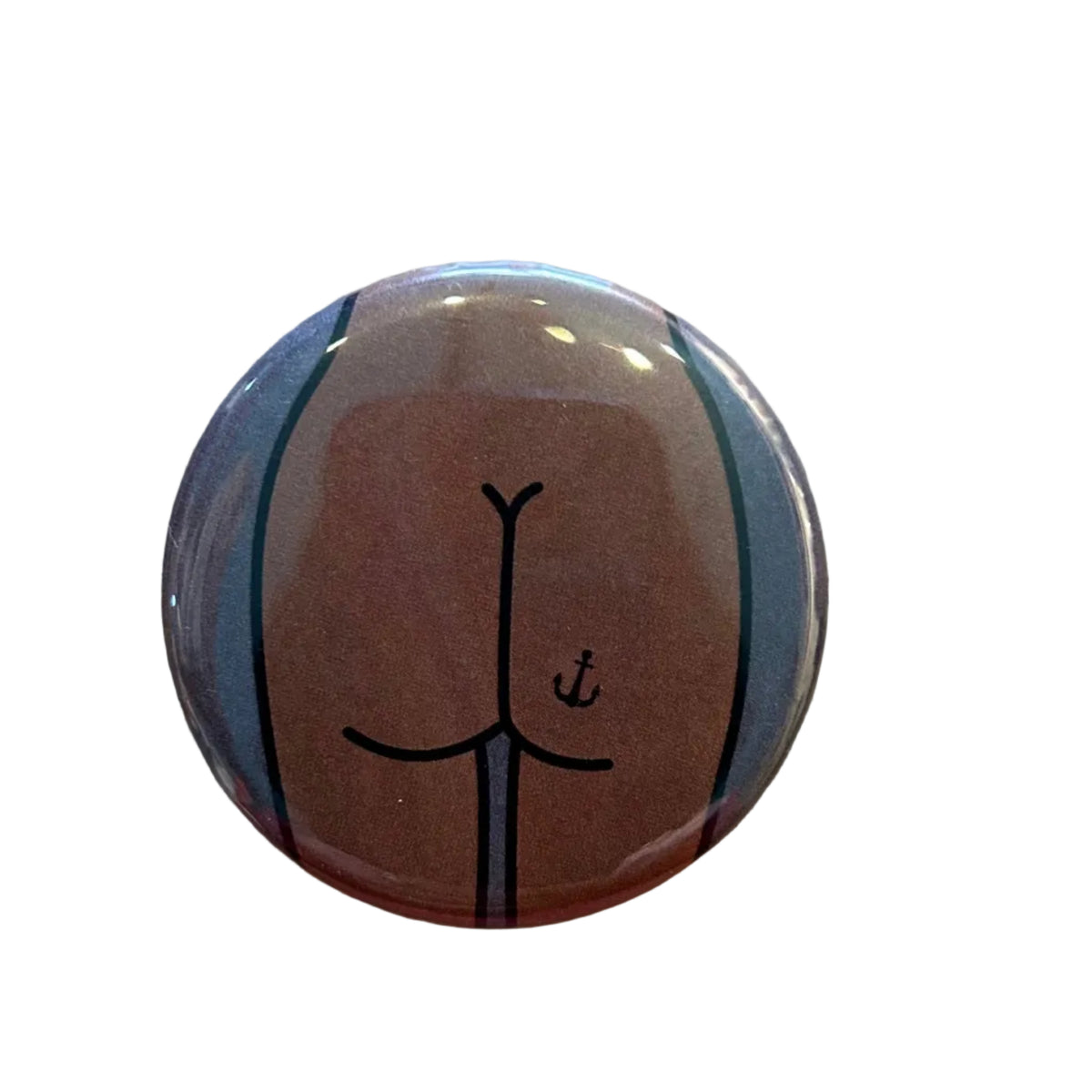 Round button with a stylized butt design with an anchor tattoo