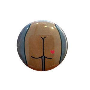 Round button with a stylized butt design 