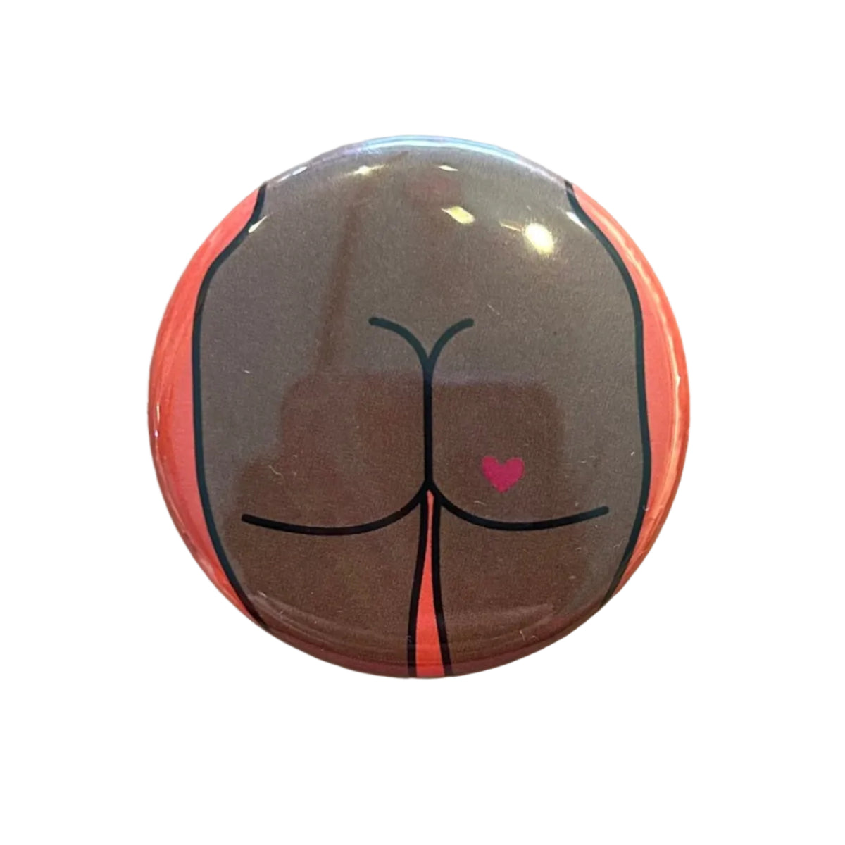 Round button badge with a buttdesign on a wooden surface