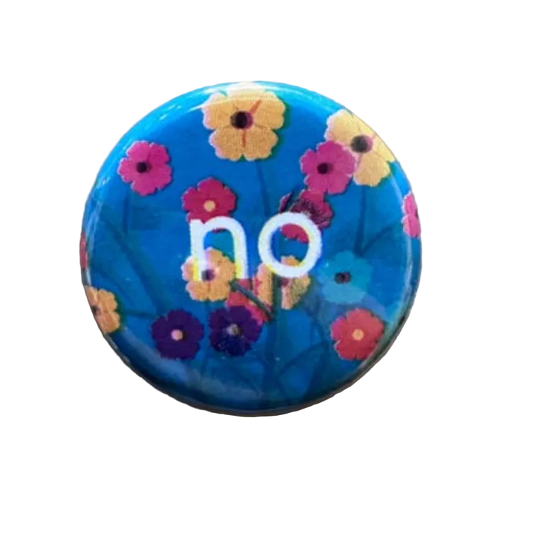 Colorful button with flowers and the word 'no' on a white background. 