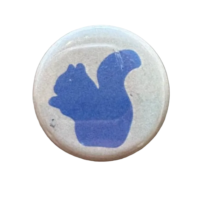 Round button with blue squirrel design 