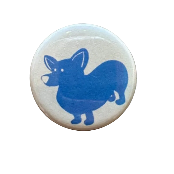 Button badge with a blue dog illustration 