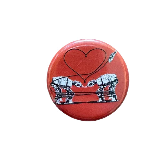 Orange button with a design of two robots forming a heart 