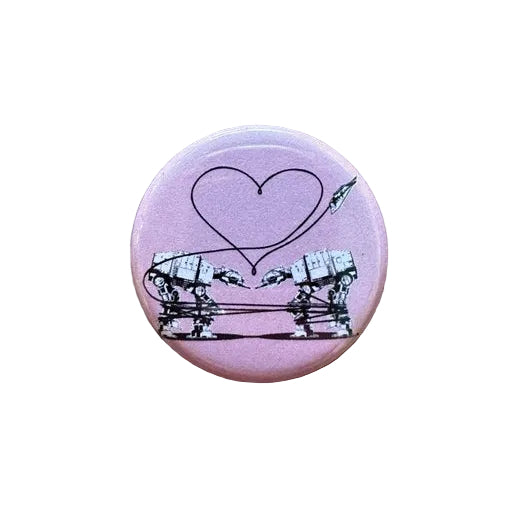 Pink button with a design of two robots and a heart 