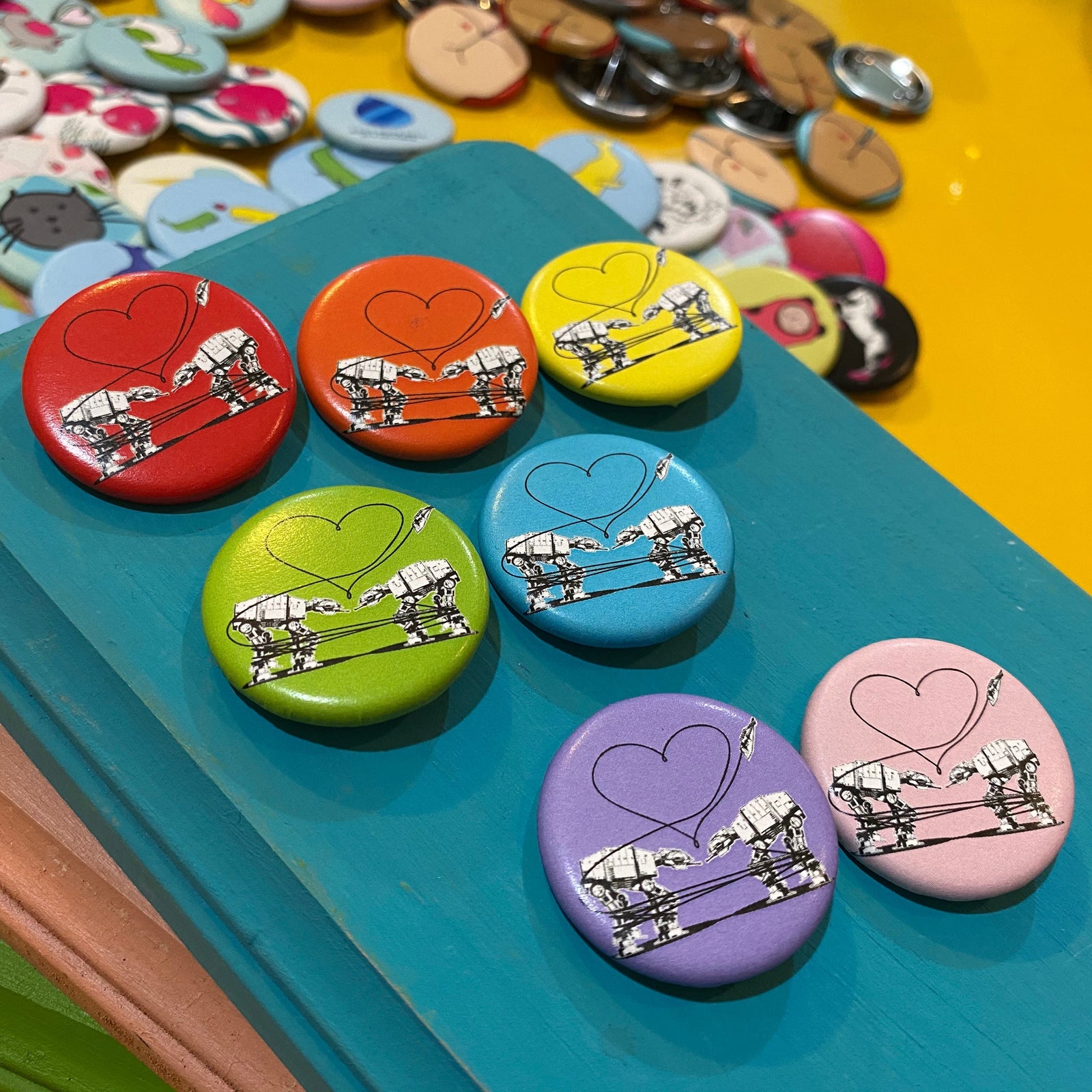 Colorful buttons with heart designs on a blue surface