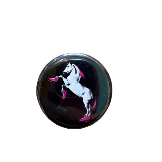 Round black button with a unicorn design 