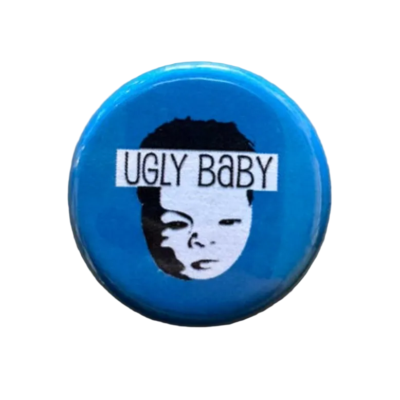 Blue button with 'UGLY BABY' text and a face graphic 