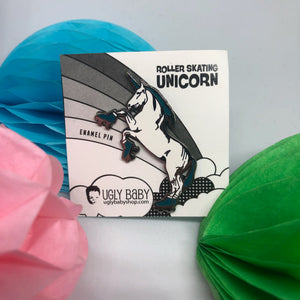A unicorn wearing roller skates. She has an aqua mane, horn and roller skates. Shown with a backing card & surrounded by crepe paper decorations.