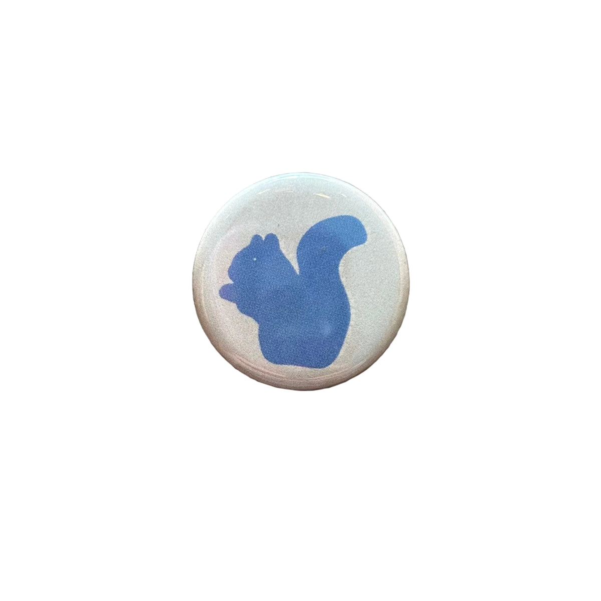 A round white button with a blue silhouette drawing of a squirrel. 