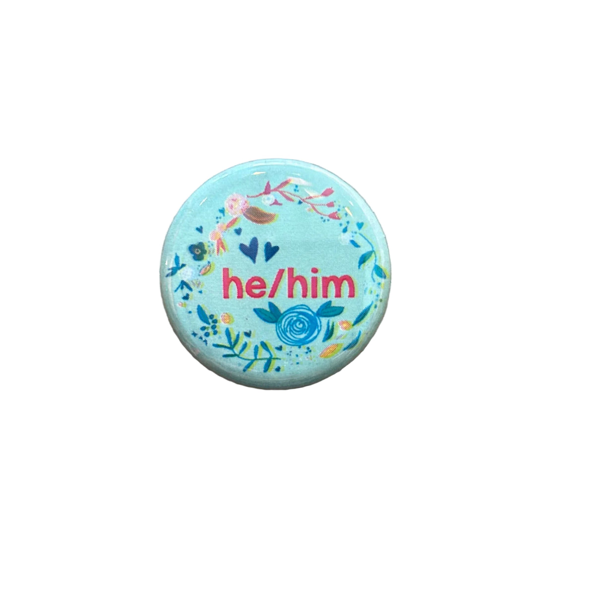 Round mint colored magnet with floral designs and text that says "he/him" on a white background. 