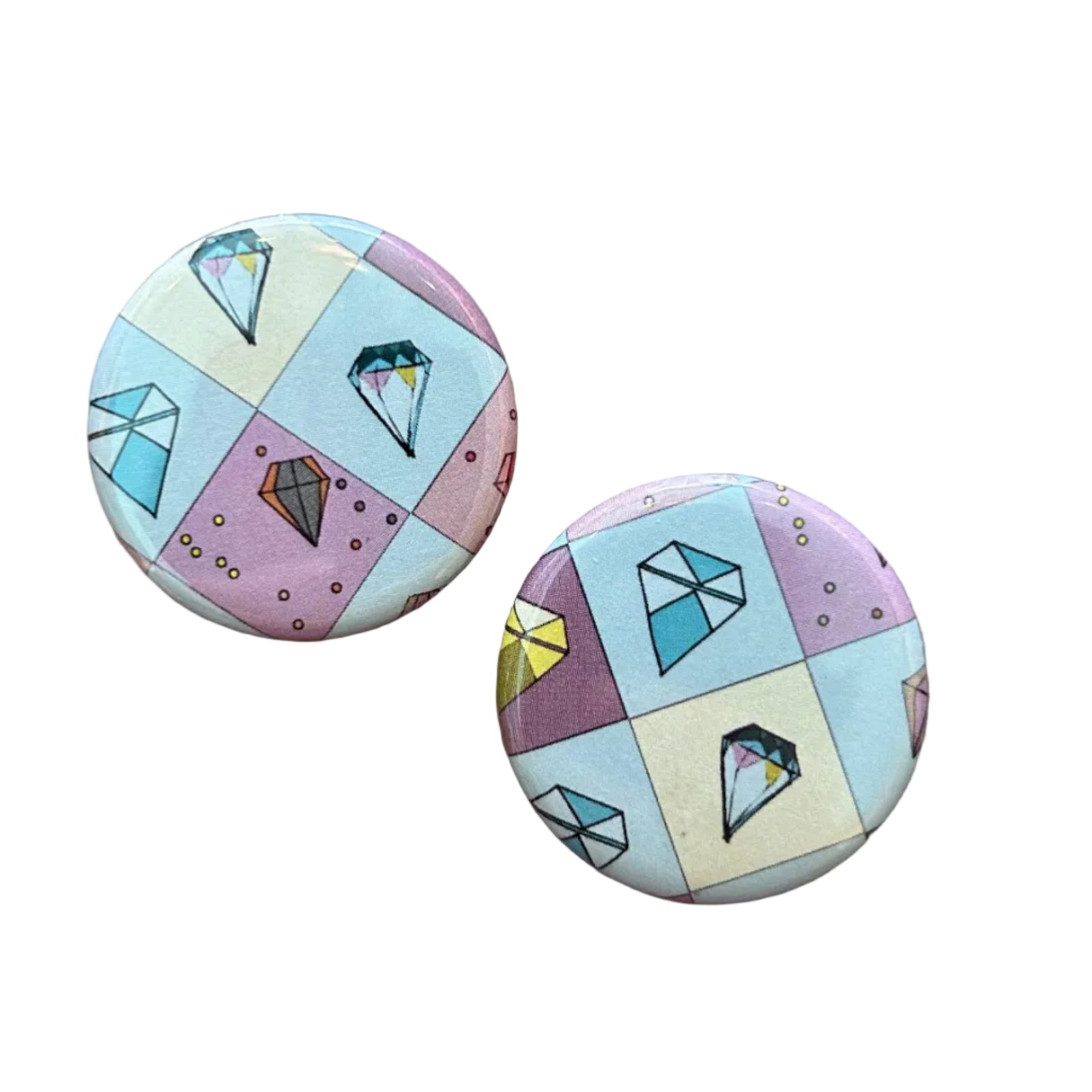 Two round magnets with a geometric pattern and gem illustrations. 
