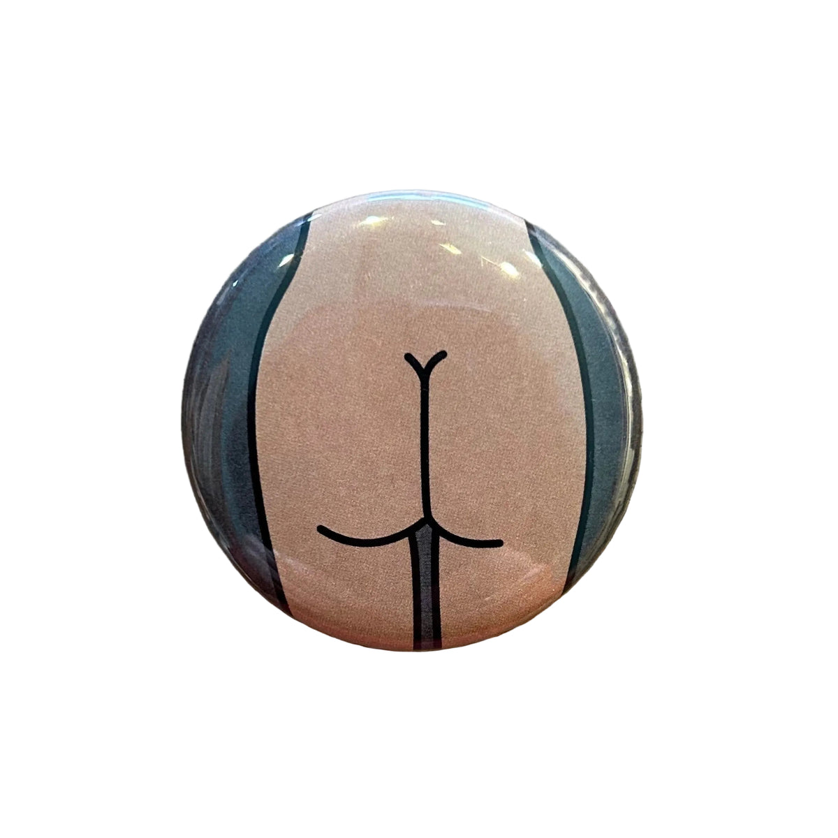 Round magnet with a cartoon illustration of a butt on a white background. 