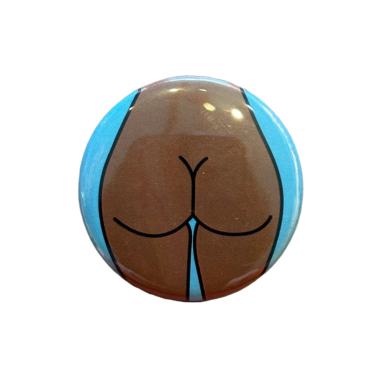 Round magnet with a cartoon illustration of a butt against a white background