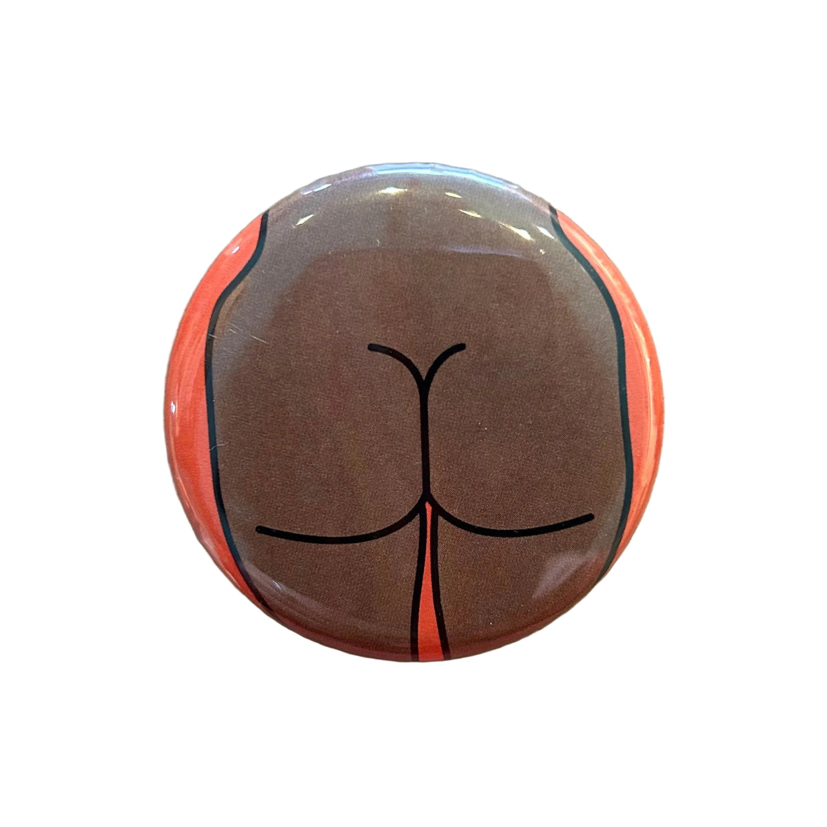 Round magnet with a cartoon illustration of a butt against a white background