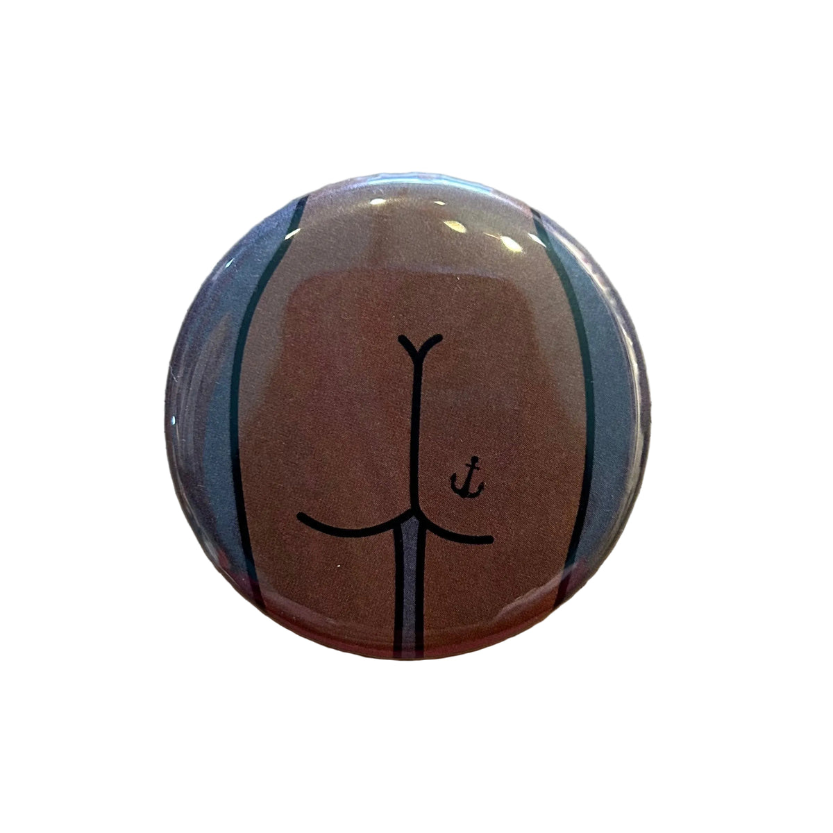 Round magnet with a cartoon illustration of a butt against a white background. 