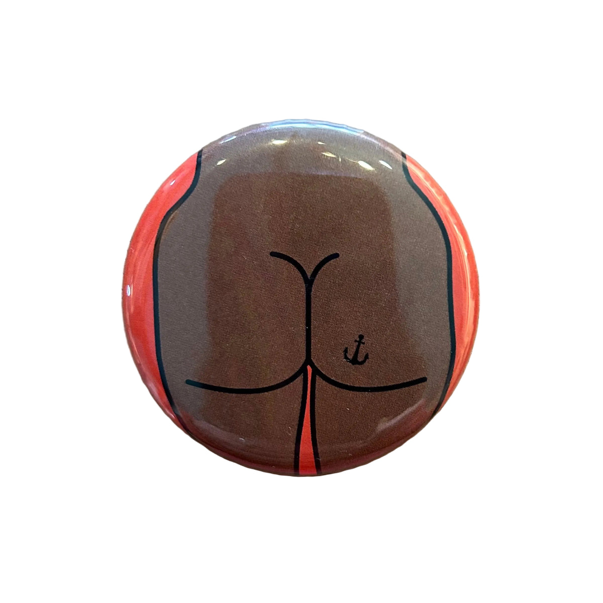 Round magnet with a cartoon illustration of a butt against a white background