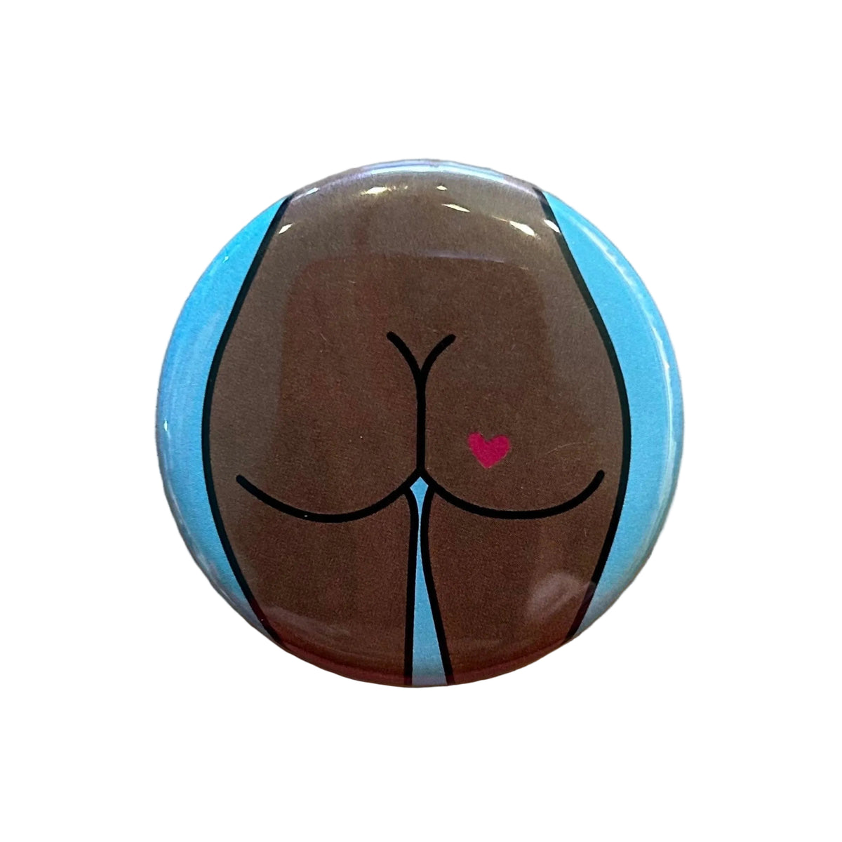 Round magnet with a cartoon illustration of a butt against a white background