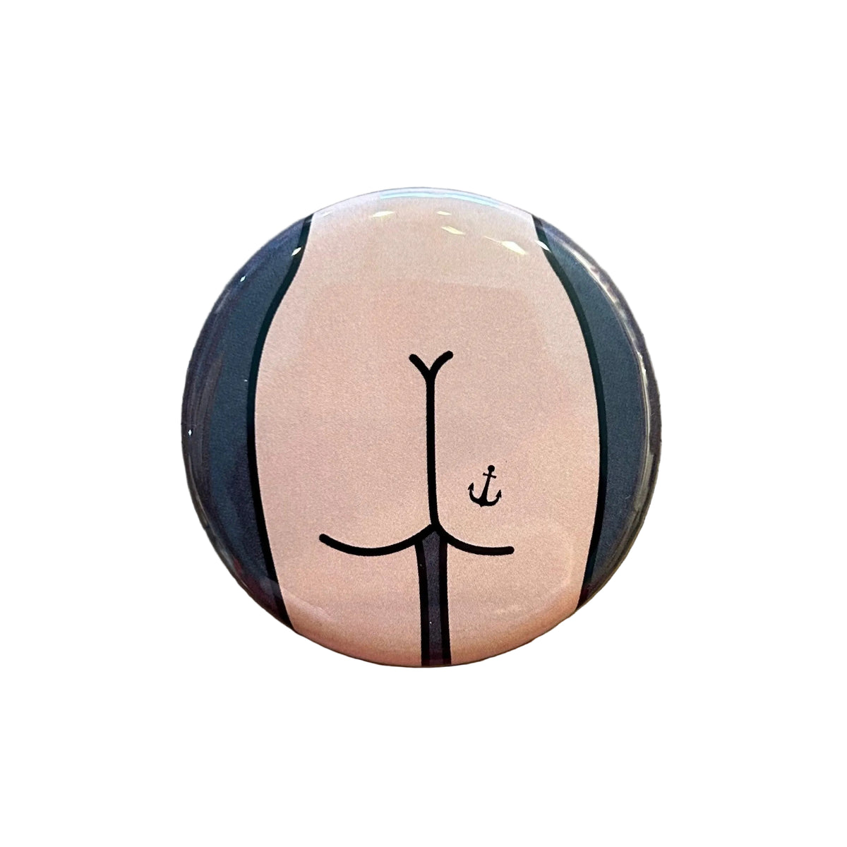 Round magnet with a butt design against a white background. 