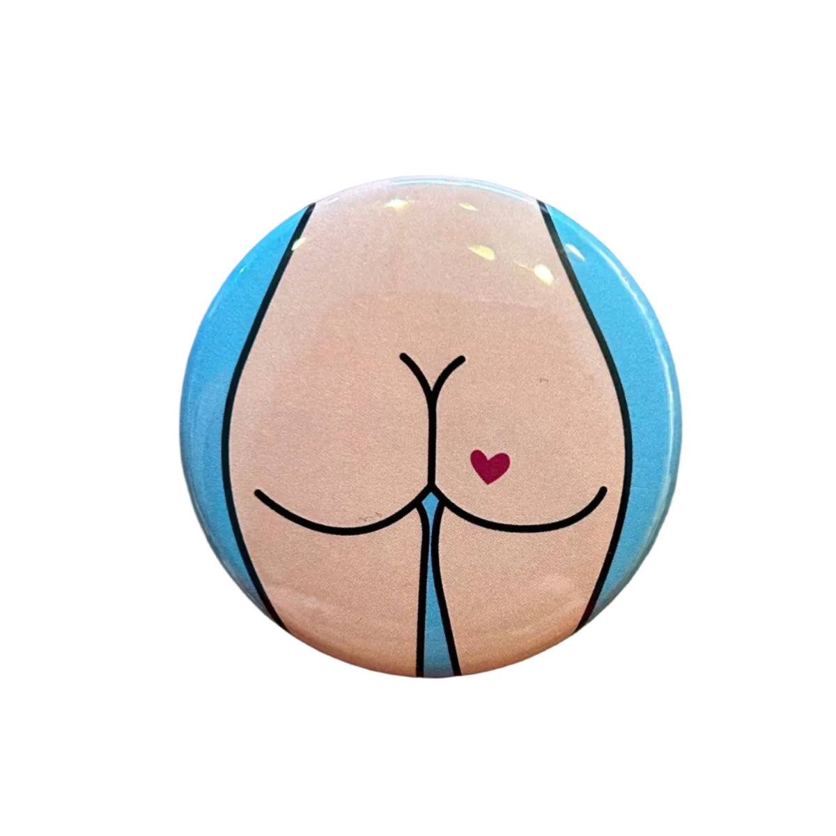 Round magnet with a cartoon butt illustration against a white background. 