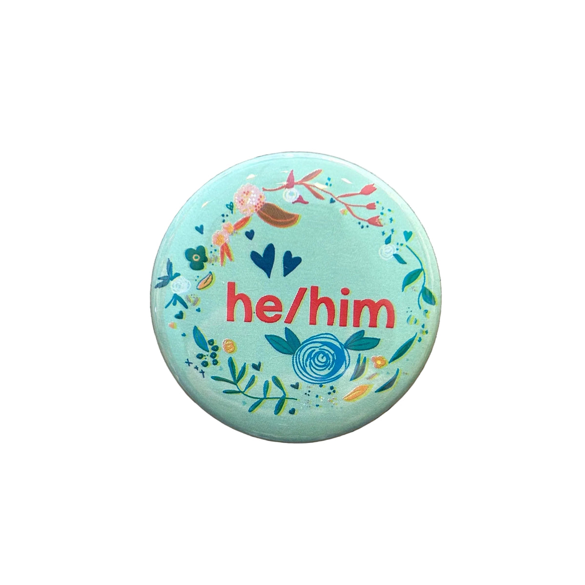 Round mint magnet with a floral border and text in the middle that says "he/him"