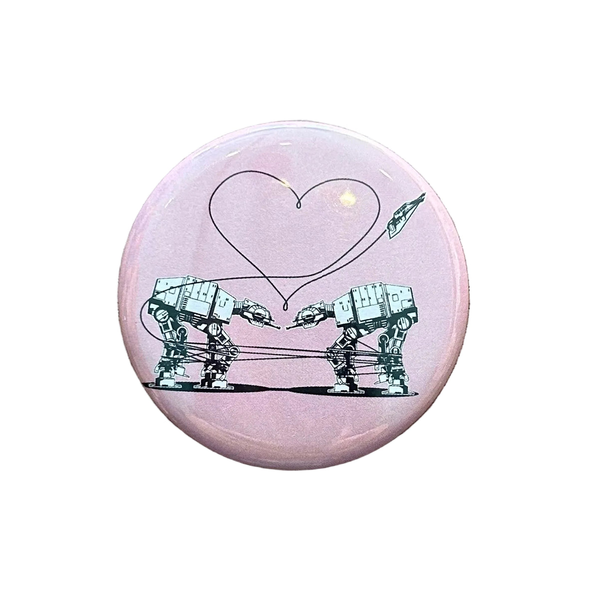 Round pink magnet with an illustration of two AT-ATs from Star Wars with a heart above them. 
