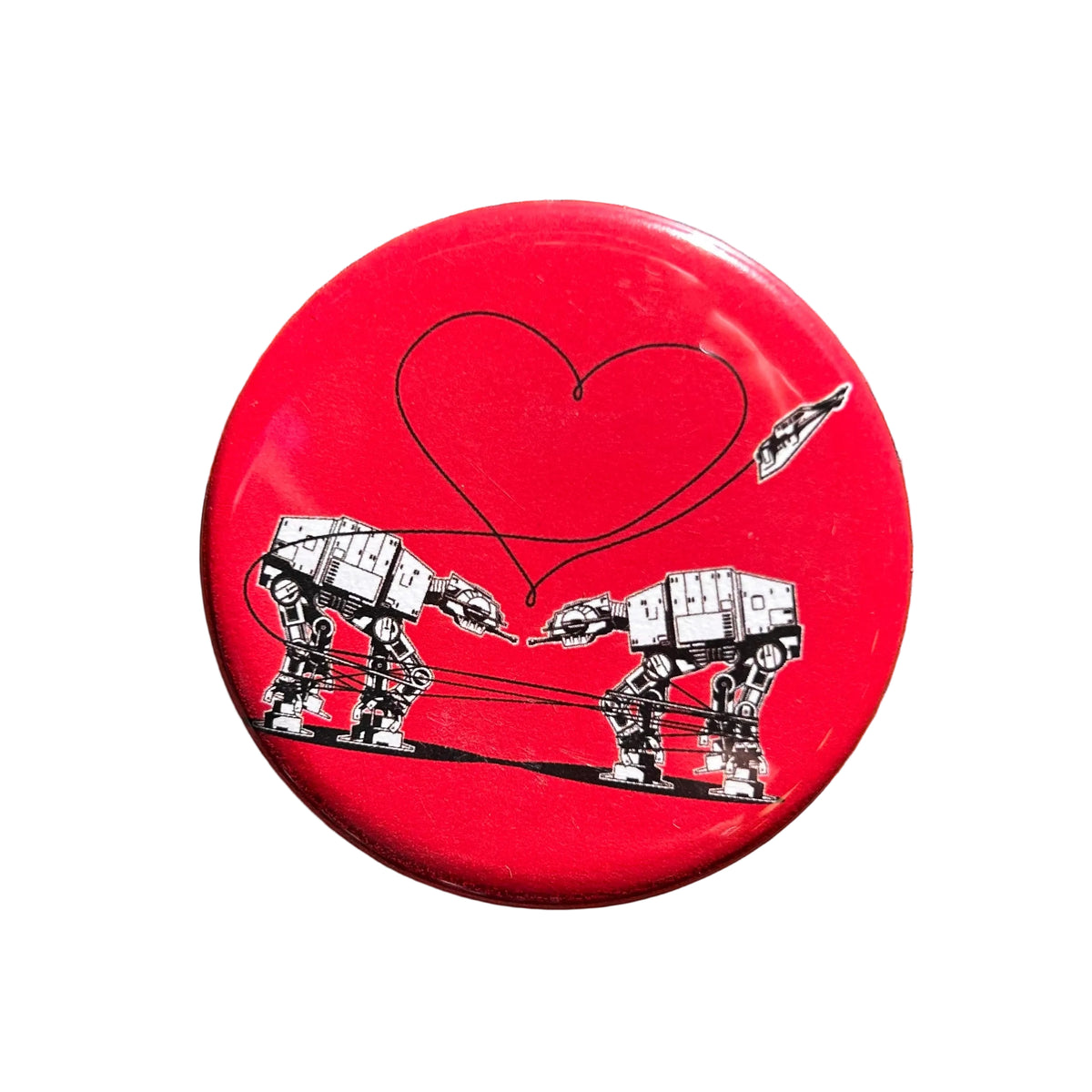 Round red magnet with an illustration of two AT-ATs from Star Wars with a heart above them