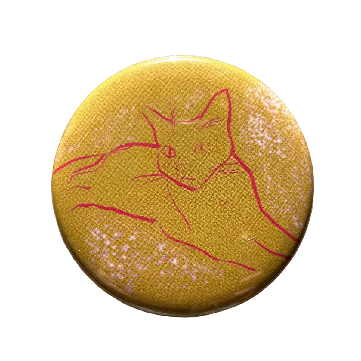 Round yellow magnet with a drawing of a cat and dots in the background. 