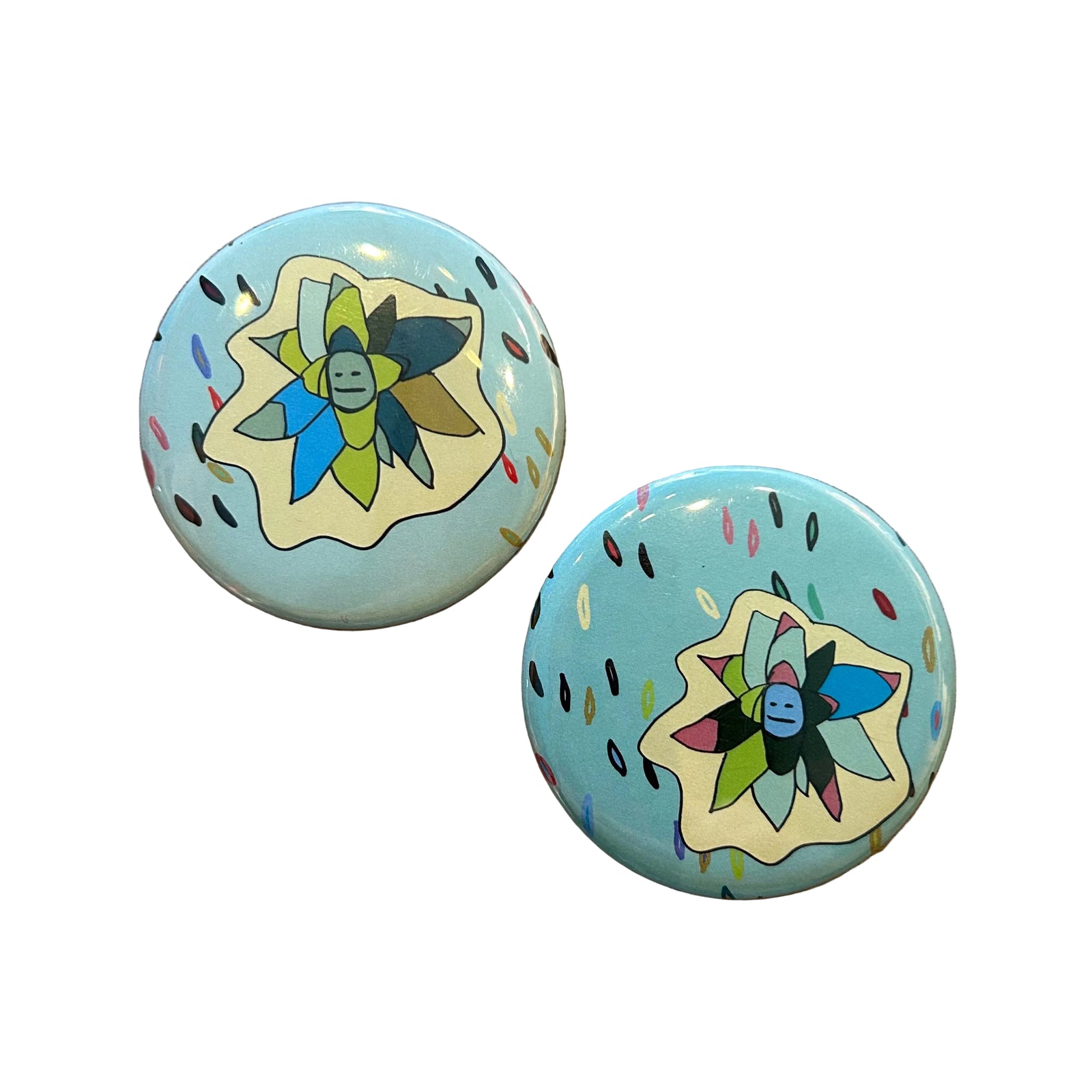 Two round blue magnets with succulent illustrations on them. 