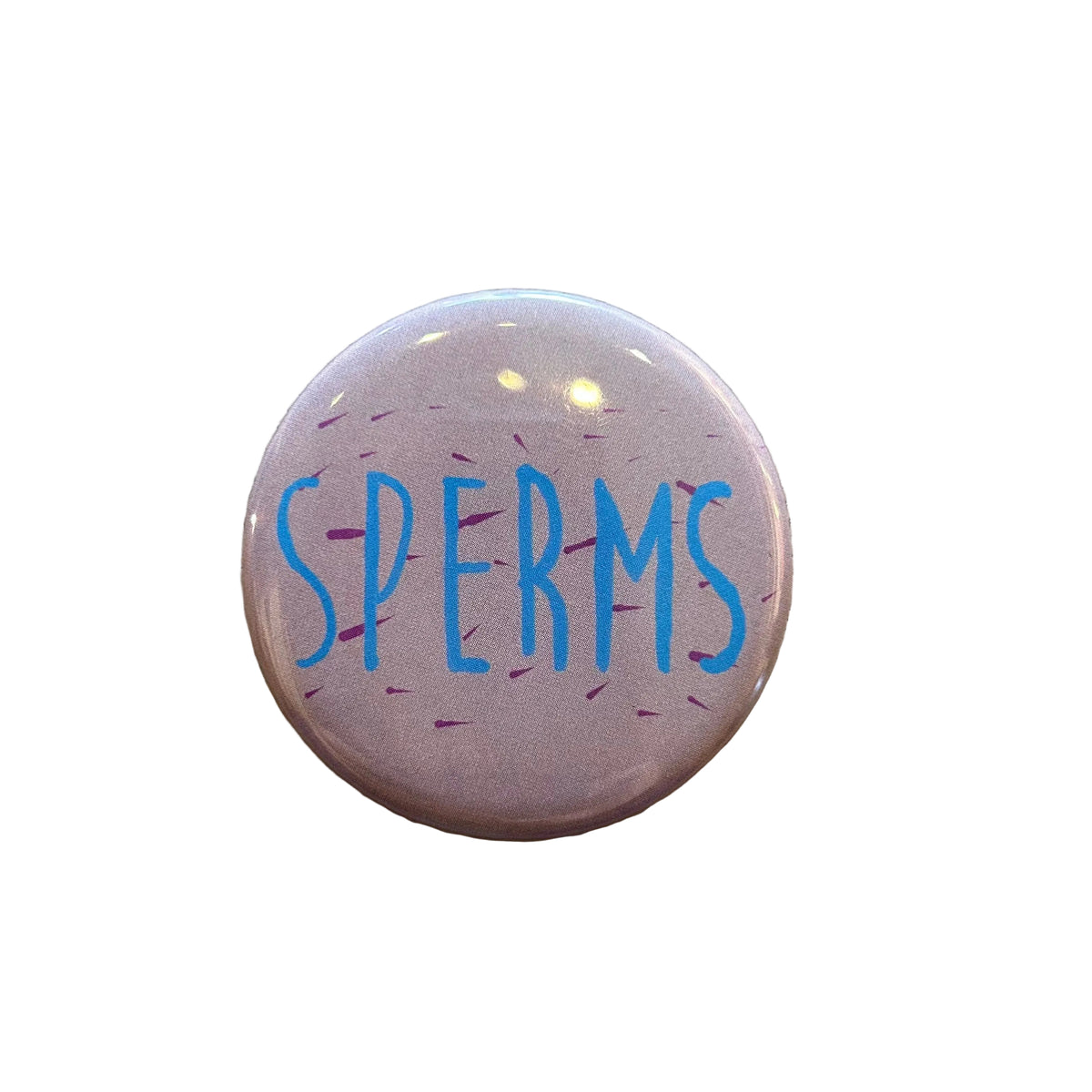 Round pink magnet with red dashes and blue text that says "SPERMS"