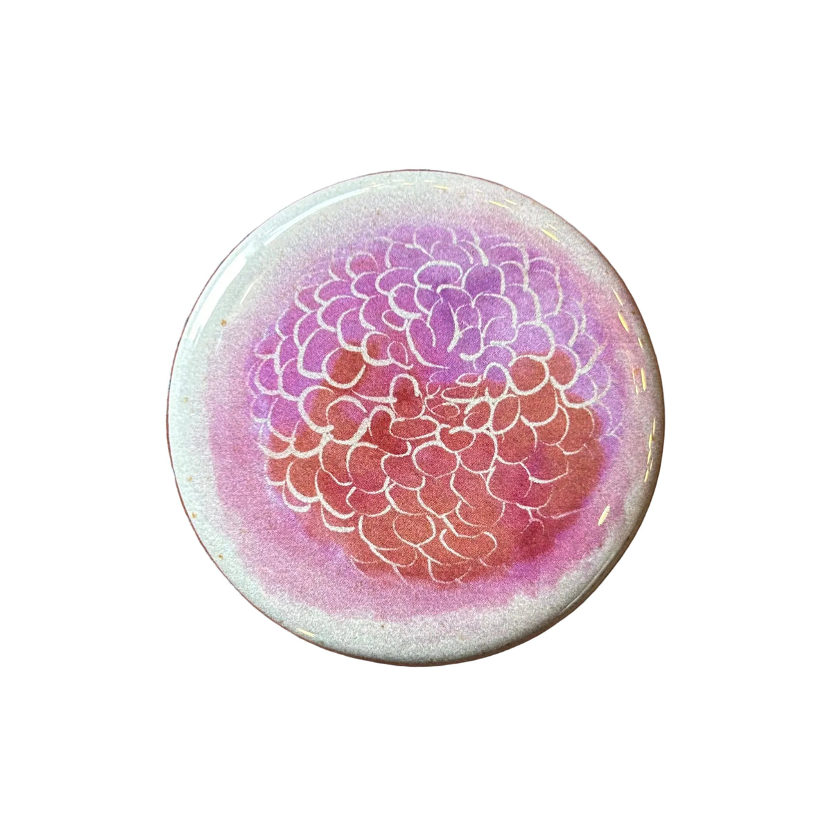 Round magnet with a watercolor illustration of a many-petaled flower. 