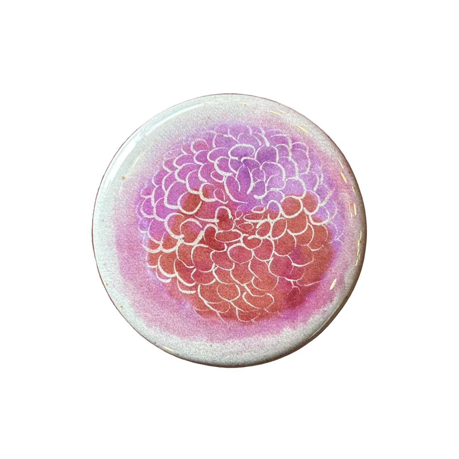 Round magnet with a watercolor illustration of a many-petaled flower. 