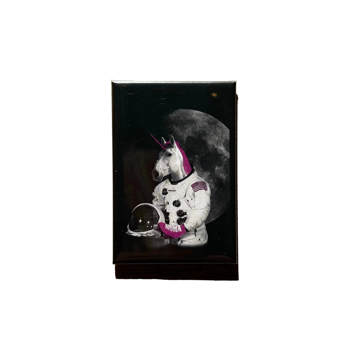 Rectangular magnet with a design of a unicorn in an astronaut suit wearing roller skates.