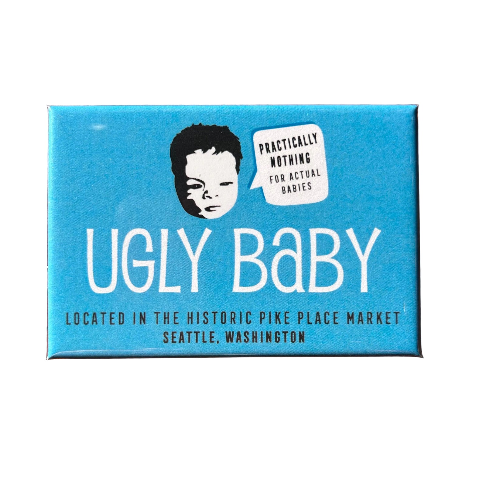 Blue rectangular magnet with an illustration of a baby head with a speech bubble that says "Practically nothing for actual babies" and text that says "UGLY BABY/Located in the historic Pike Place Market/Seattle, Washington"