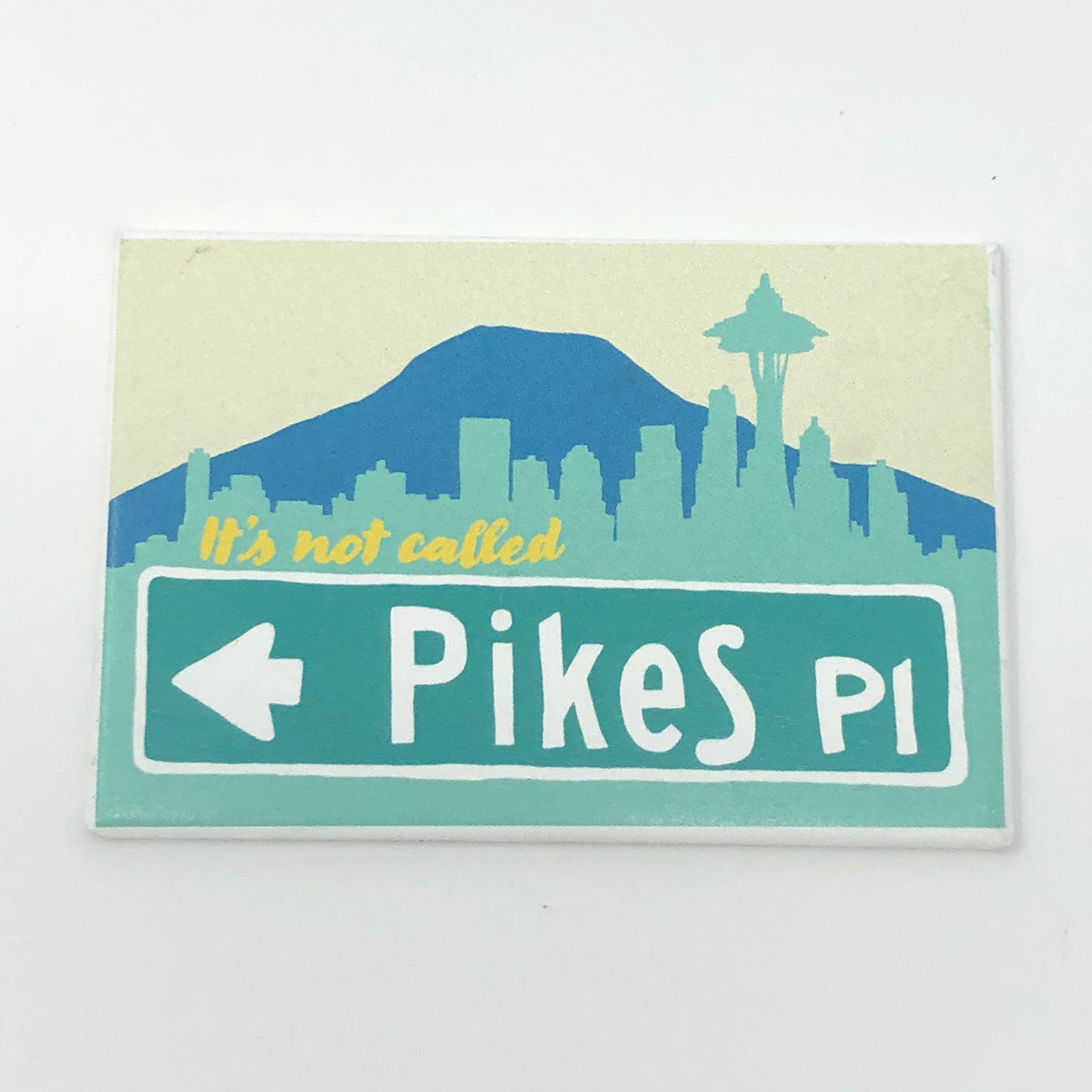 Rectangular magnet with an illustration of the Seattle skyline and text that says "it's not called PikeS Pl"