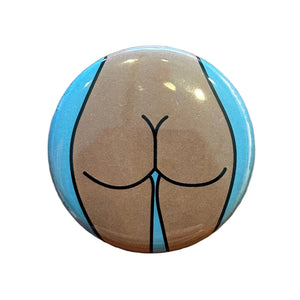 Round mirror with a design of a cartoon butt on the back. 