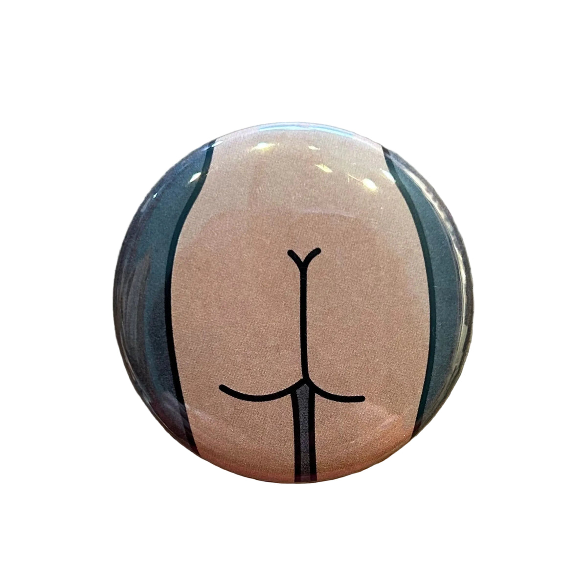 Round mirror with a cartoon illustration of a butt on the back.