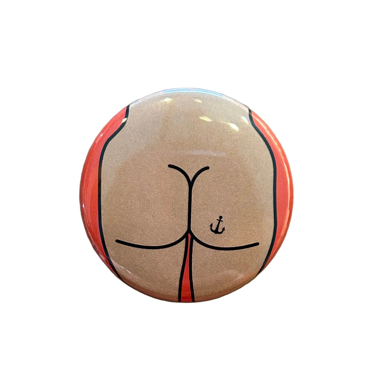 Round mirror with a cartoon illustration of a butt with an anchor tattoo on the back. 