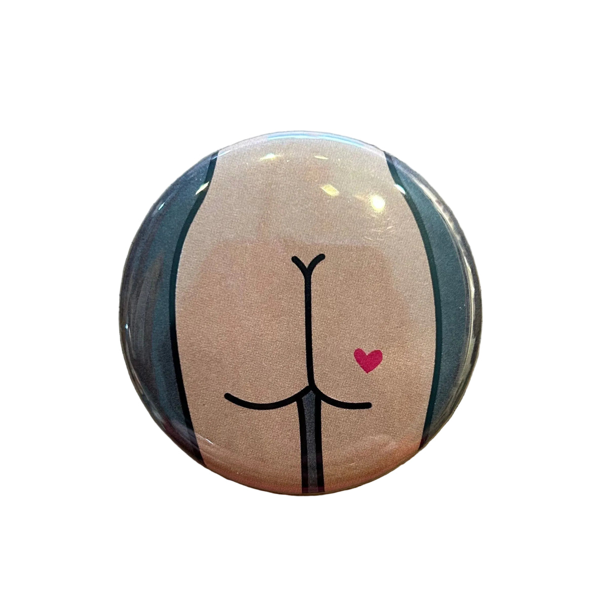 Round mirror with a cartoon illustration of a butt with a heart tattoo on the back 