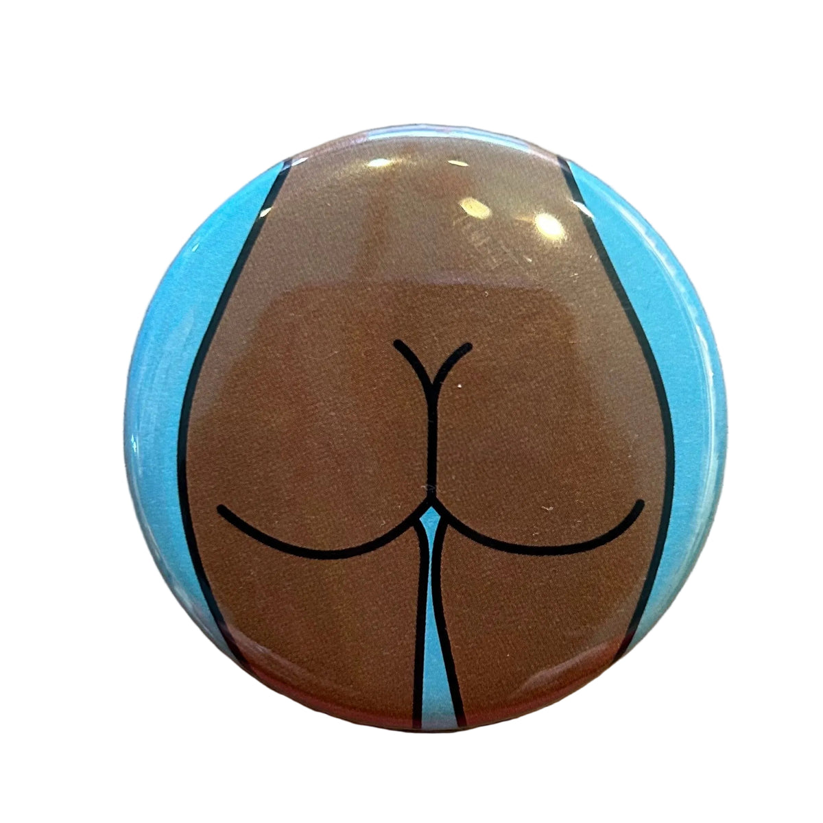 Round mirror with a cartoon illustration of a butt on the back. 
